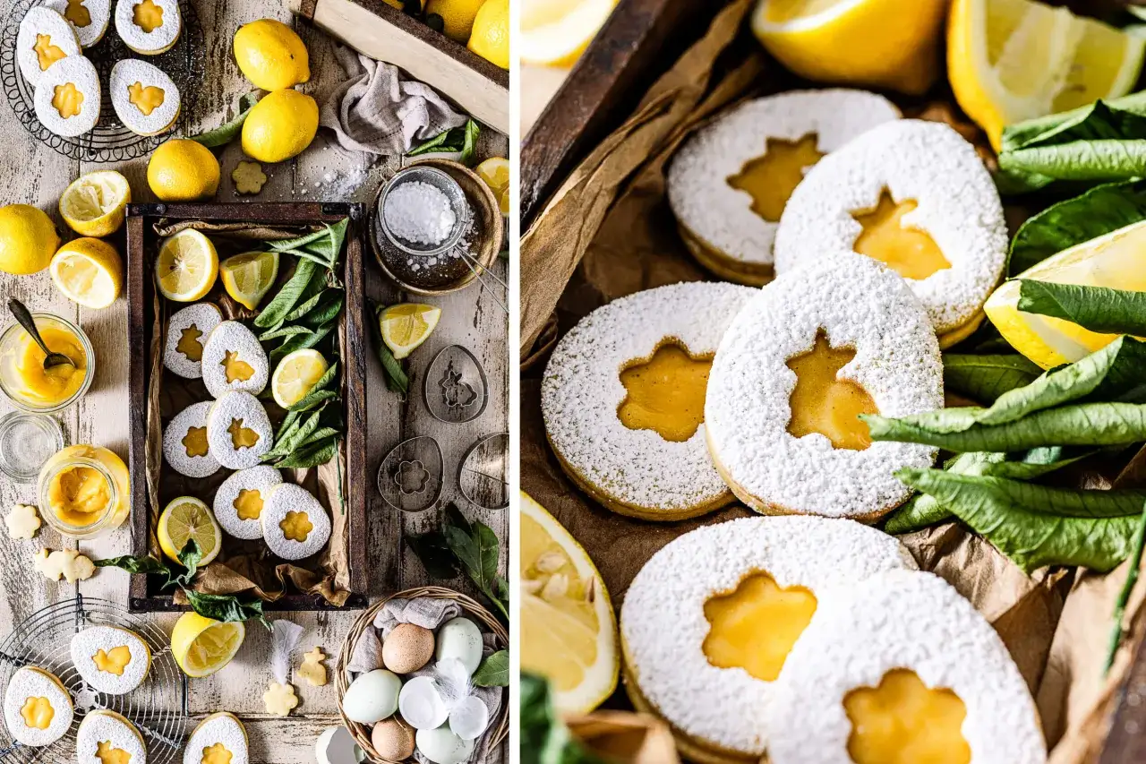 Zitronen-Canestrini mit Puderzucker und Zitronencreme, umgeben von frischen Zitronen und grünen Blättern.